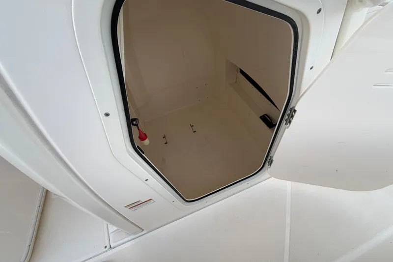 Slide: The Image of Open storage compartment on a 2023 Boston Whaler 220 Dauntless boat. - 54