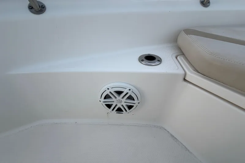 Slide: The Image of 2023 Boston Whaler 220 Dauntless interior detail with speaker and seating area. - 57