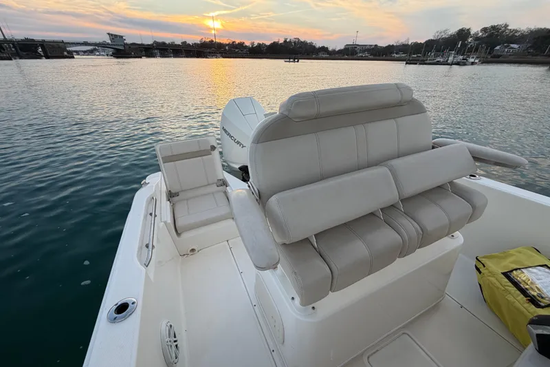 Slide: The Image of 2023 Boston Whaler 220 Dauntless boat interior with sunset view. - 58