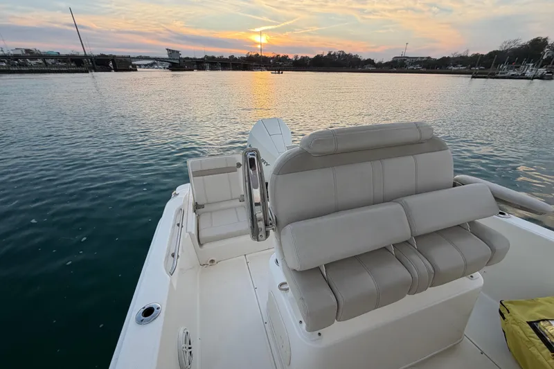 Slide: The Image of 2023 Boston Whaler 220 Dauntless boat interior at sunset on calm water. - 59