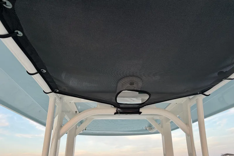 Slide: The Image of 2023 Boston Whaler 220 Dauntless boat canopy, featuring sturdy framework and mesh cover. - 62