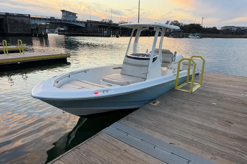 Slide: The Image of 2023 Boston Whaler 220 Dauntless docked at sunset, showcasing sleek design and modern features. - 64