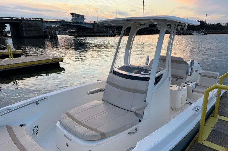 Slide: The Image of 2023 Boston Whaler 220 Dauntless boat docked at sunset near a bridge. - 65