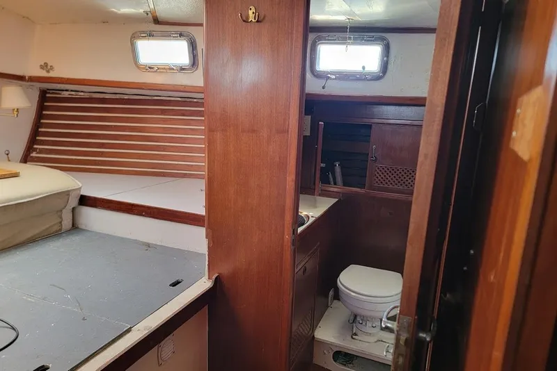 Slide: The Image of Interior of a 1981 CT 47 yacht featuring a cozy cabin and compact bathroom. - 22