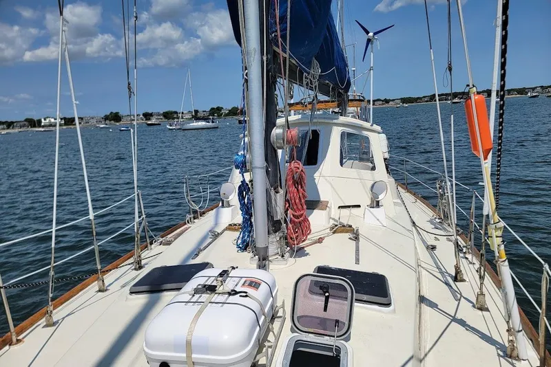 Slide: The Image of Sailboat on water, CT 47 model, 1981, with clear sky and distant shoreline. - 25