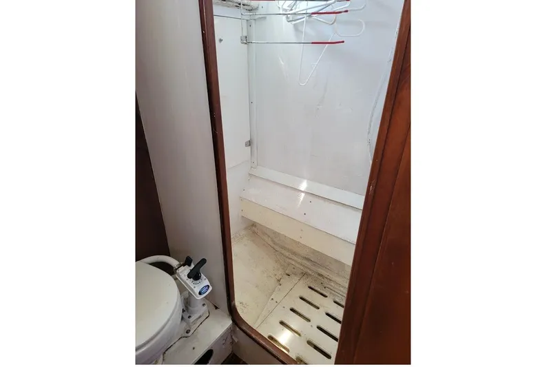 Slide: The Image of 1981 CT 47 boat bathroom with toilet and shower area. - 24