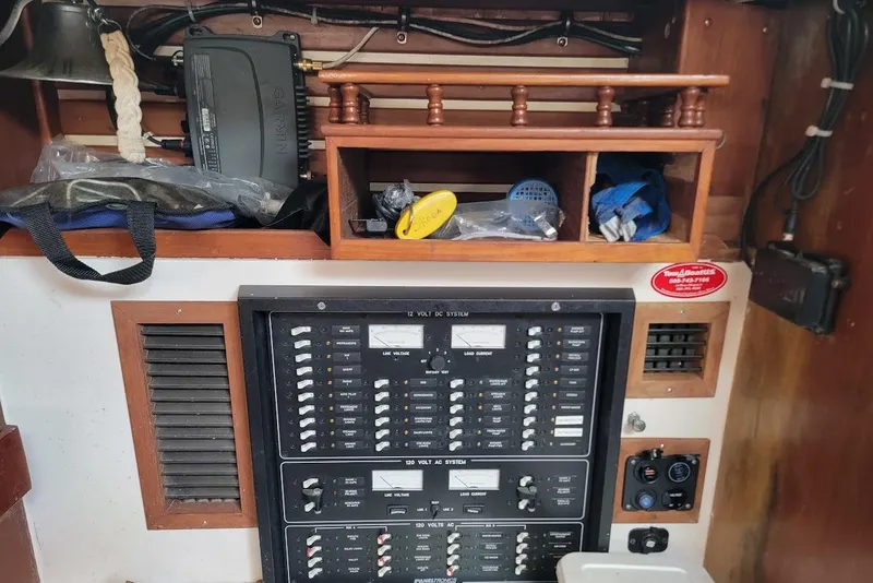 Slide: The Image of Electrical panel and storage shelves inside a 1981 CT 47 boat cabin. - 19