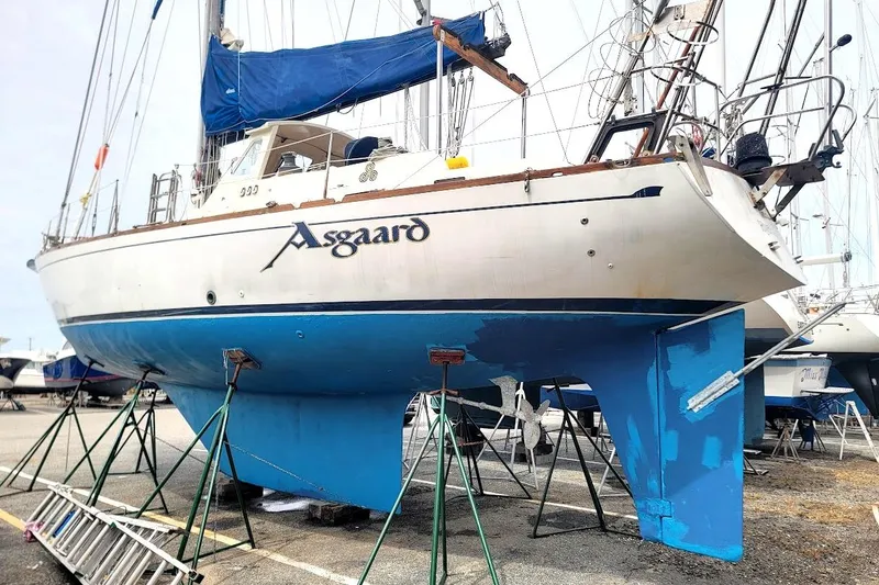 Slide: The Image of 1981 CT 47 sailboat "Asgaard" on stands, blue hull, marina setting. - 5