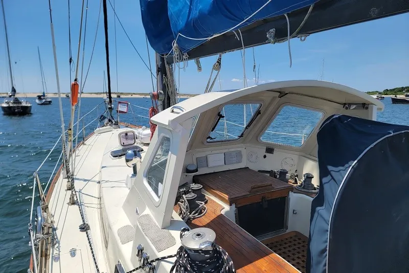 Slide: The Image of Sailboat cockpit view on water, CT 47 model, 1981, with blue sail and clear sky. - 2