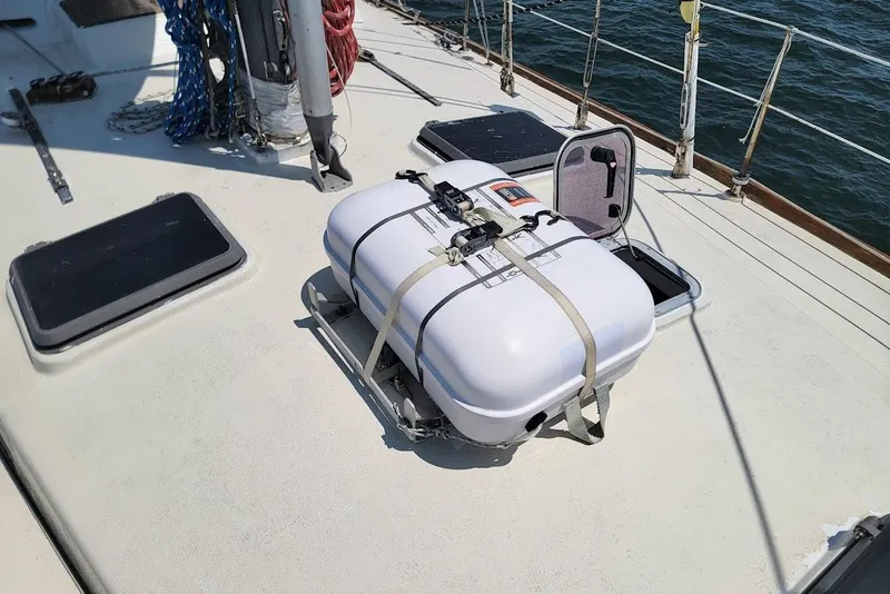Slide: The Image of Sailboat deck with secured life raft, CT 47 model, 1981, on open water. - 9