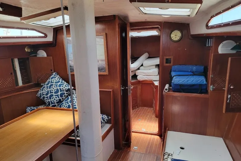Slide: The Image of Interior of a 1981 CT 47 sailboat with wooden furnishings and nautical decor. - 11