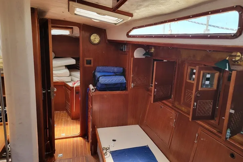 Slide: The Image of Interior of a 1981 CT 47 sailboat with wooden cabinetry and nautical decor. - 13