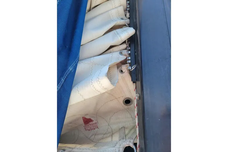 Slide: The Image of Close-up of a 1981 CT 47 sailboat sail with hardware and stitching details. - 28