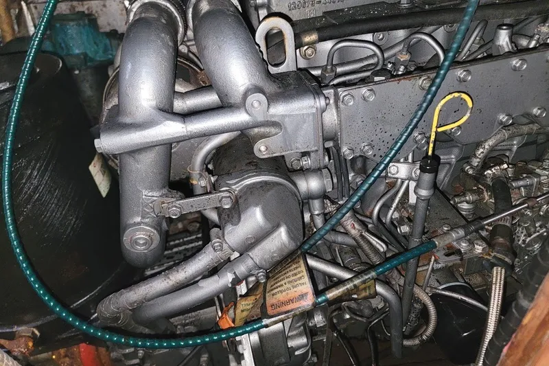 Slide: The Image of 1982 CT 47 engine with visible pipes and components in a mechanical setting. - 41