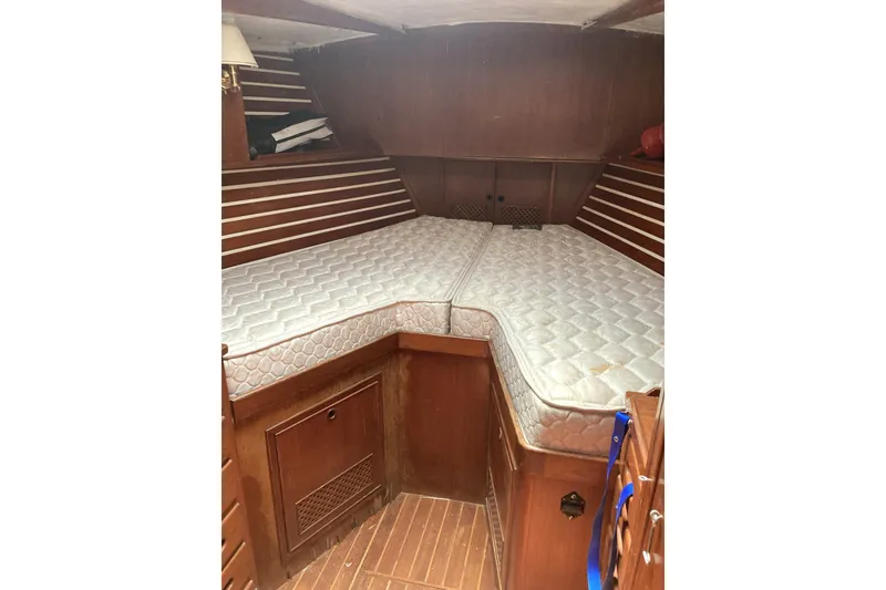Slide: The Image of 1982 CT 47 yacht interior with wooden cabin and V-berth mattresses. - 14