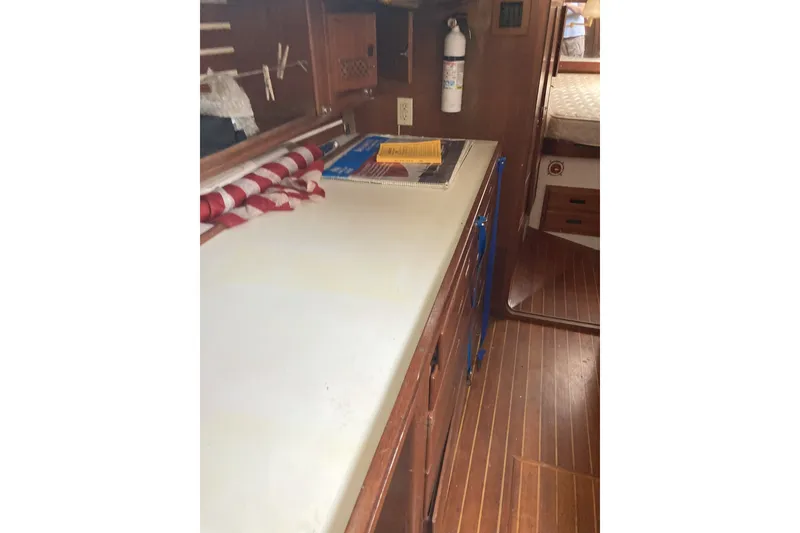 Slide: The Image of Interior of 1982 CT 47 sailboat with wooden cabinetry and countertop. - 39