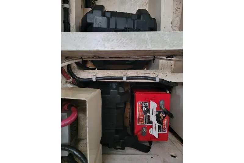 Slide: The Image of Battery compartment of a 1982 CT 47 model, featuring red and black components. - 45