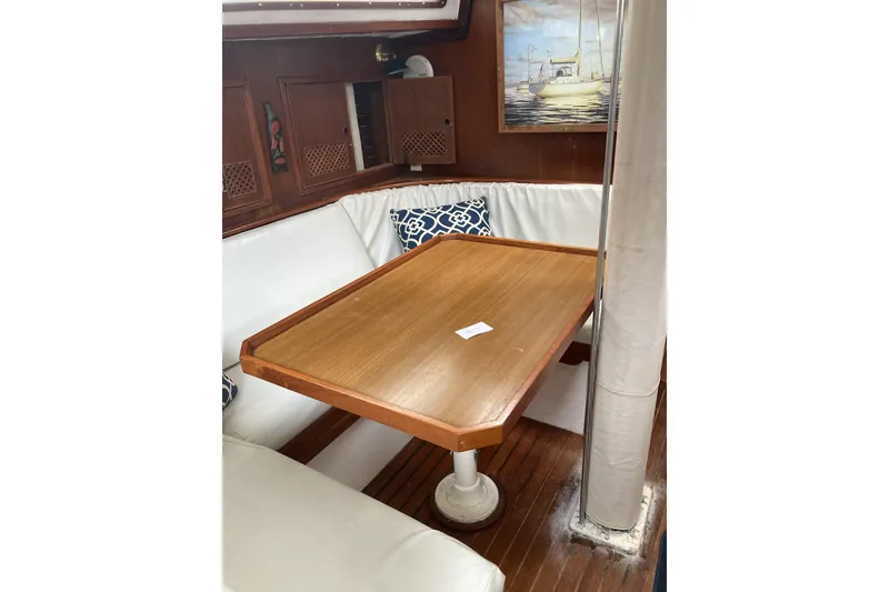 Slide: The Image of 1982 CT 47 yacht interior with wooden table and cushioned seating. - 10