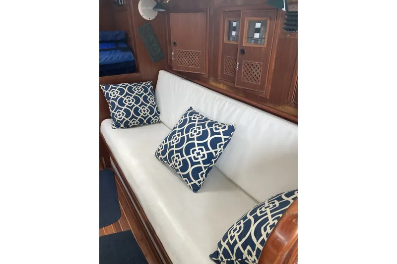 Slide: The Image of White cushioned seating with blue patterned pillows in a 1982 CT 47 model interior. - 12