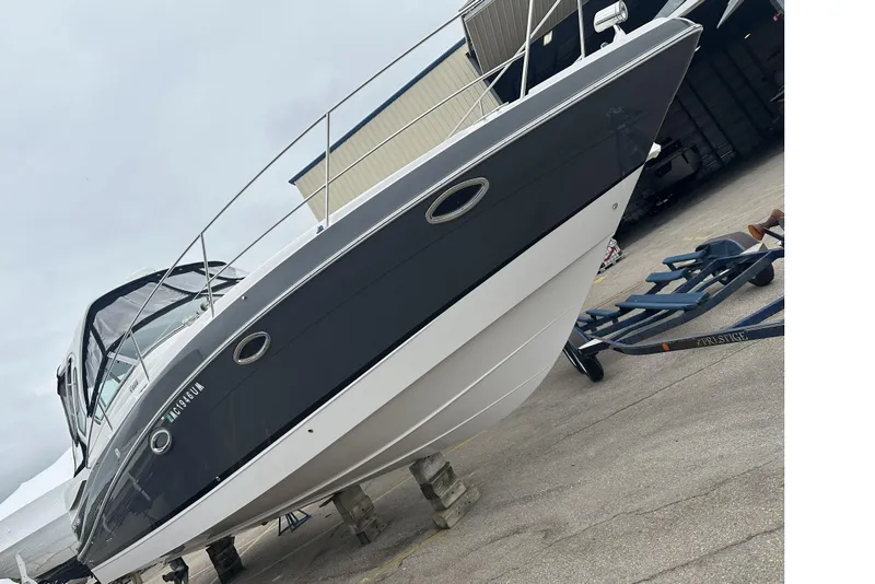 The Image of 2018 Four Winns V355 boat on trailer, displayed outdoors. - 0