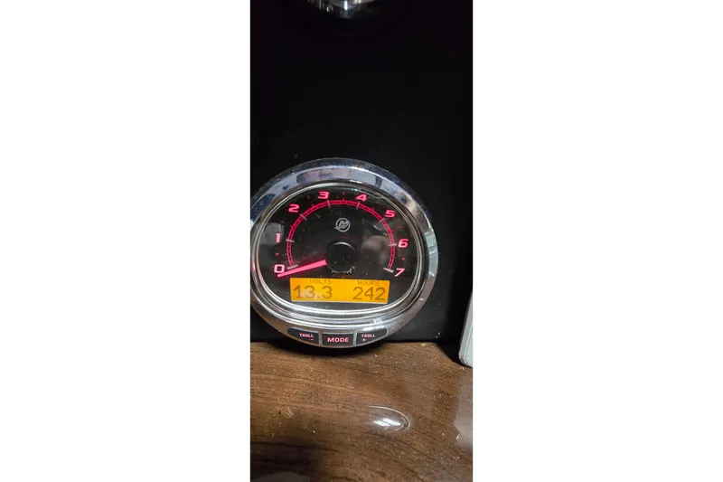 Slide: The Image of Close-up of a 2018 Four Winns V355 boat tachometer displaying 13.3 volts and 242 hours. - 11