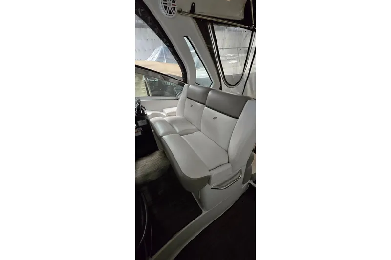 Slide: The Image of Interior of 2018 Four Winns V355 boat with sleek white seating and modern design. - 16