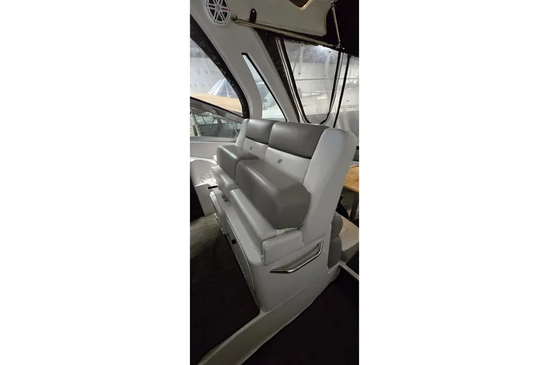 Slide: The Image of 2018 Four Winns V355 boat interior with gray seating and large windows. - 17