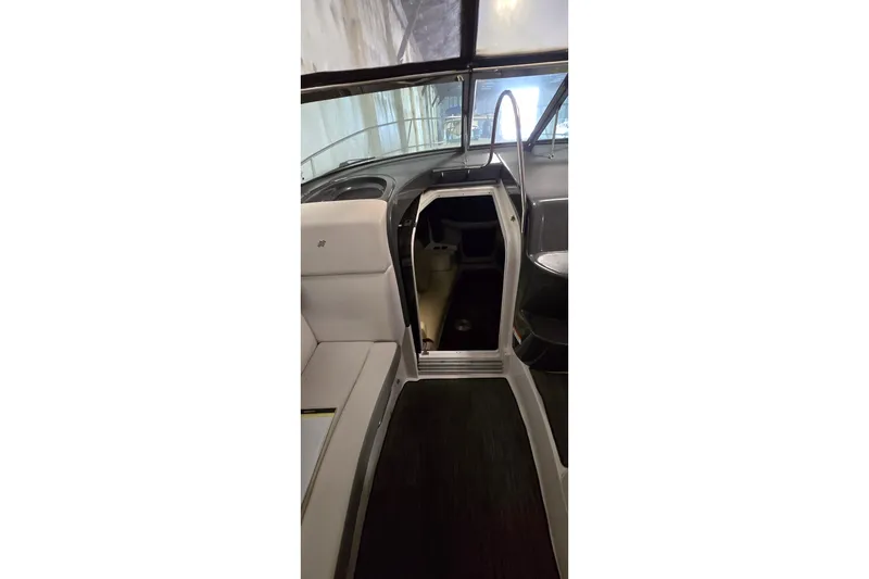 Slide: The Image of Interior view of 2018 Four Winns V355 boat, featuring seating and cabin entrance. - 22