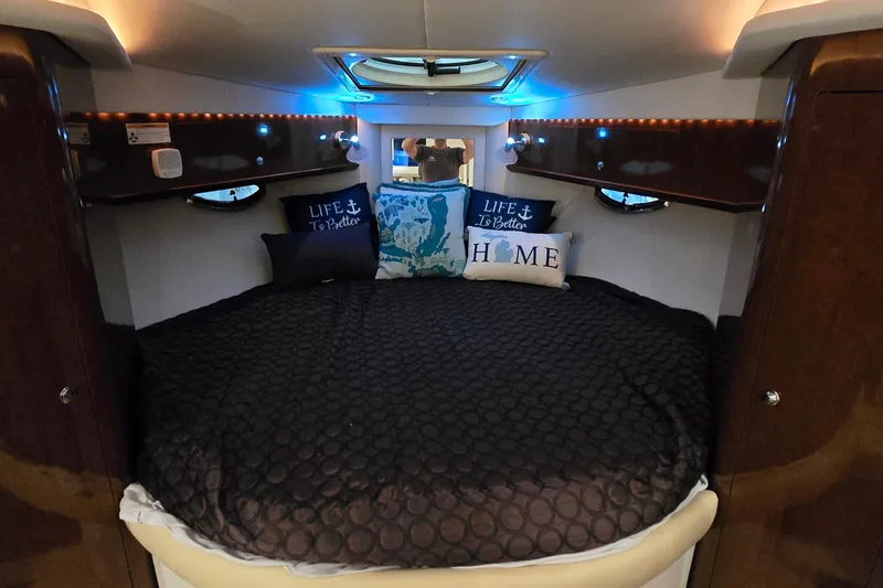 Slide: The Image of Cozy cabin interior of 2018 Four Winns V355 boat with decorative pillows and ambient lighting. - 23