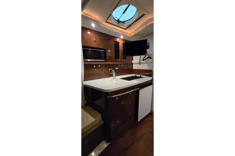 Slide: The Image of 2018 Four Winns V355 yacht interior kitchen with modern appliances and sleek design. - 31
