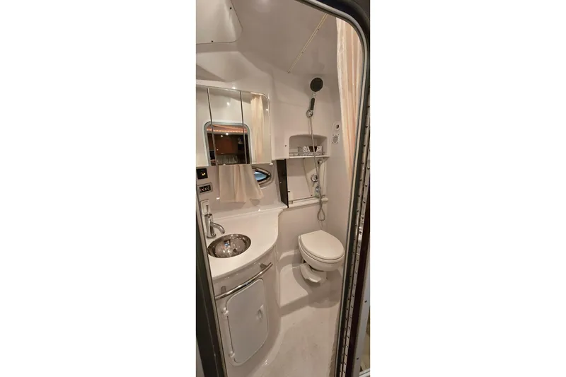 Slide: The Image of Compact bathroom in 2018 Four Winns V355 boat, featuring sink, toilet, and shower. - 34