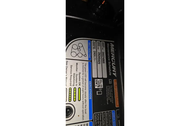 Slide: The Image of Label on a 2018 Four Winns V355 boat engine, detailing Mercury maintenance schedule. - 38