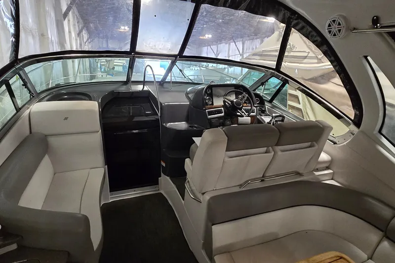 Slide: The Image of Interior of a 2018 Four Winns V355 boat, featuring a modern helm and seating area. - 4