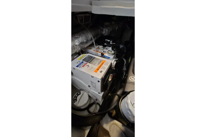 Slide: The Image of Engine compartment of a 2018 Four Winns V355 boat, showcasing mechanical components. - 41