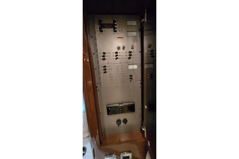 Slide: The Image of Electrical control panel inside 2018 Four Winns V355 boat, featuring switches and gauges. - 47