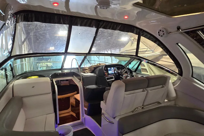 Slide: The Image of Interior of a 2018 Four Winns V355 boat, featuring a modern helm and seating area. - 5