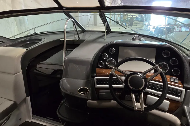 Slide: The Image of 2018 Four Winns V355 boat cockpit with steering wheel and control panel. - 9