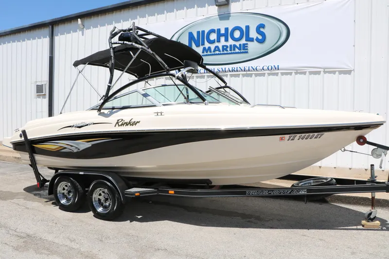 The Image of 2004 Rinker 212 Captiva Bowrider boat on trailer at Nichols Marine dealership. - 1