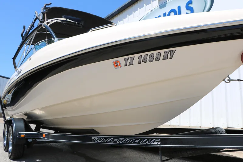 Slide: The Image of 2004 Rinker 212 Captiva Bowrider on a trailer, side view with registration number. - 13