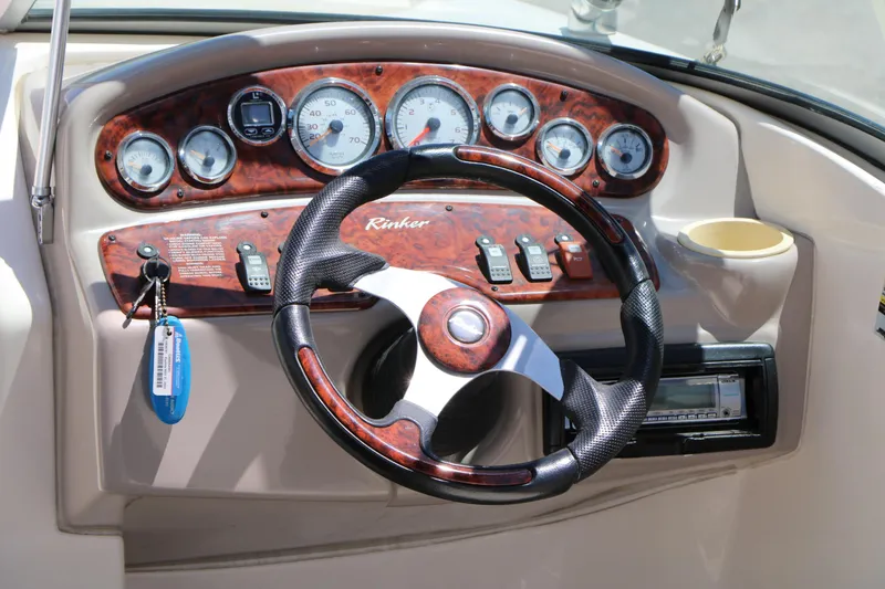 Slide: The Image of Dashboard of a 2004 Rinker 212 Captiva Bowrider with steering wheel and gauges. - 25