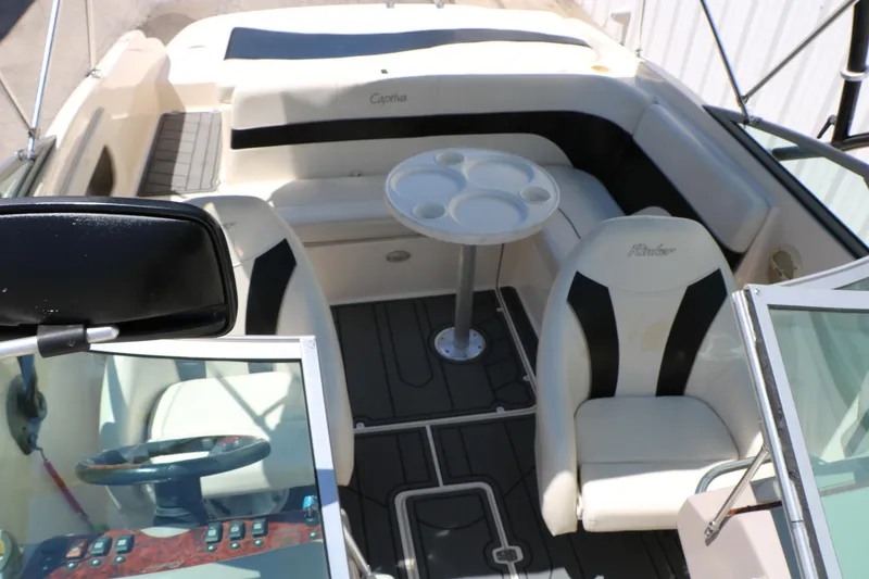 Slide: The Image of 2004 Rinker 212 Captiva Bowrider interior with seating and table, showcasing luxury design. - 32
