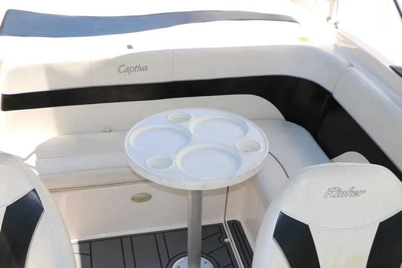 Slide: The Image of 2004 Rinker 212 Captiva Bowrider interior with seating and round table. - 33