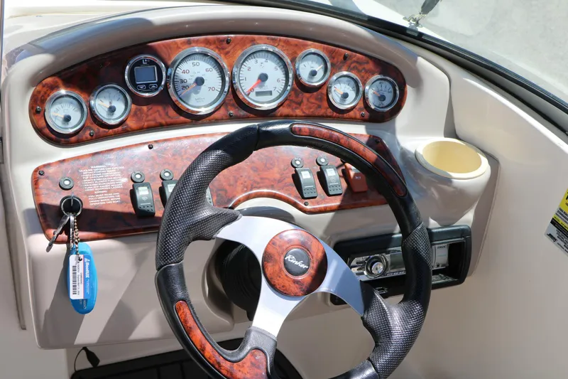 Slide: The Image of Dashboard of a 2004 Rinker 212 Captiva Bowrider with wood accents and gauges. - 38