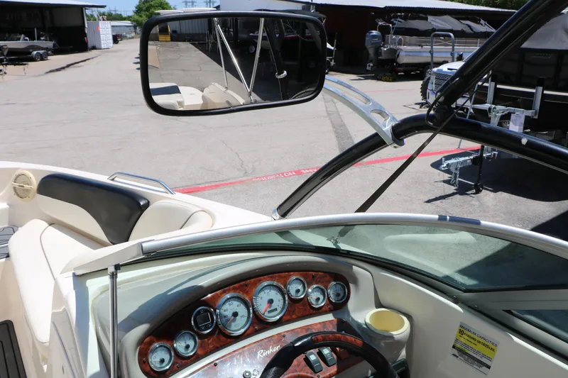 Slide: The Image of 2004 Rinker 212 Captiva Bowrider dashboard with gauges and rearview mirror. - 40