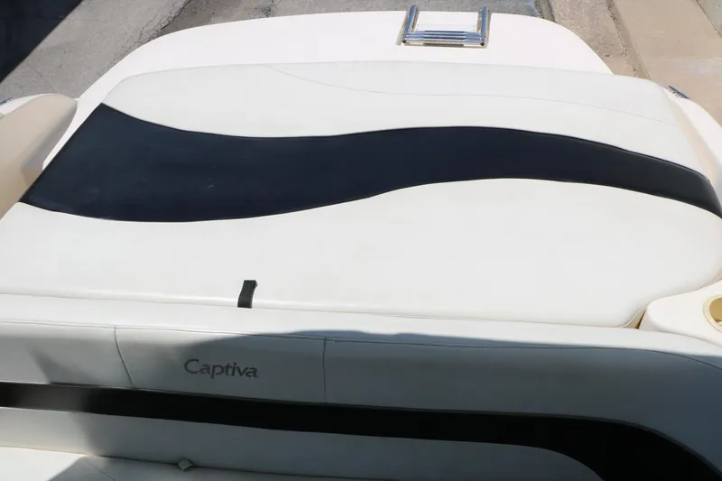 Slide: The Image of 2004 Rinker 212 Captiva Bowrider boat interior with white and black seating. - 43