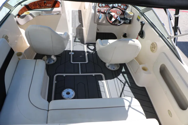 Slide: The Image of 2004 Rinker 212 Captiva Bowrider interior with seating and steering wheel. - 45