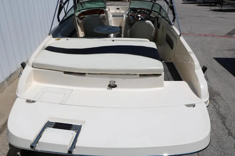 Slide: The Image of 2004 Rinker 212 Captiva Bowrider boat, rear view, showcasing seating and deck layout. - 6