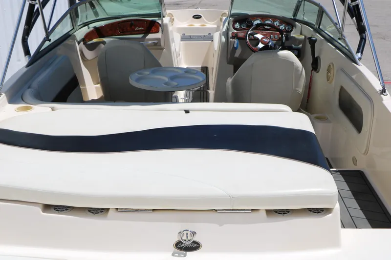 Slide: The Image of 2004 Rinker 212 Captiva Bowrider interior with seating, steering wheel, and dashboard. - 8