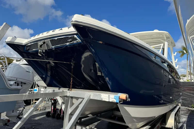 The Image of 2026 World Cat 280 DC-X boat on trailer under clear blue sky. - 0