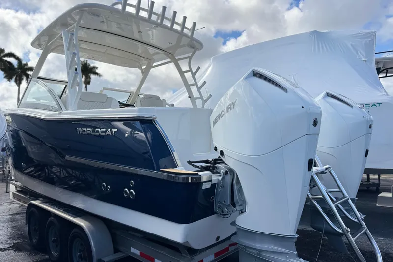 Slide: The Image of 2026 World Cat 280 DC-X boat with dual Mercury engines on a trailer. - 2